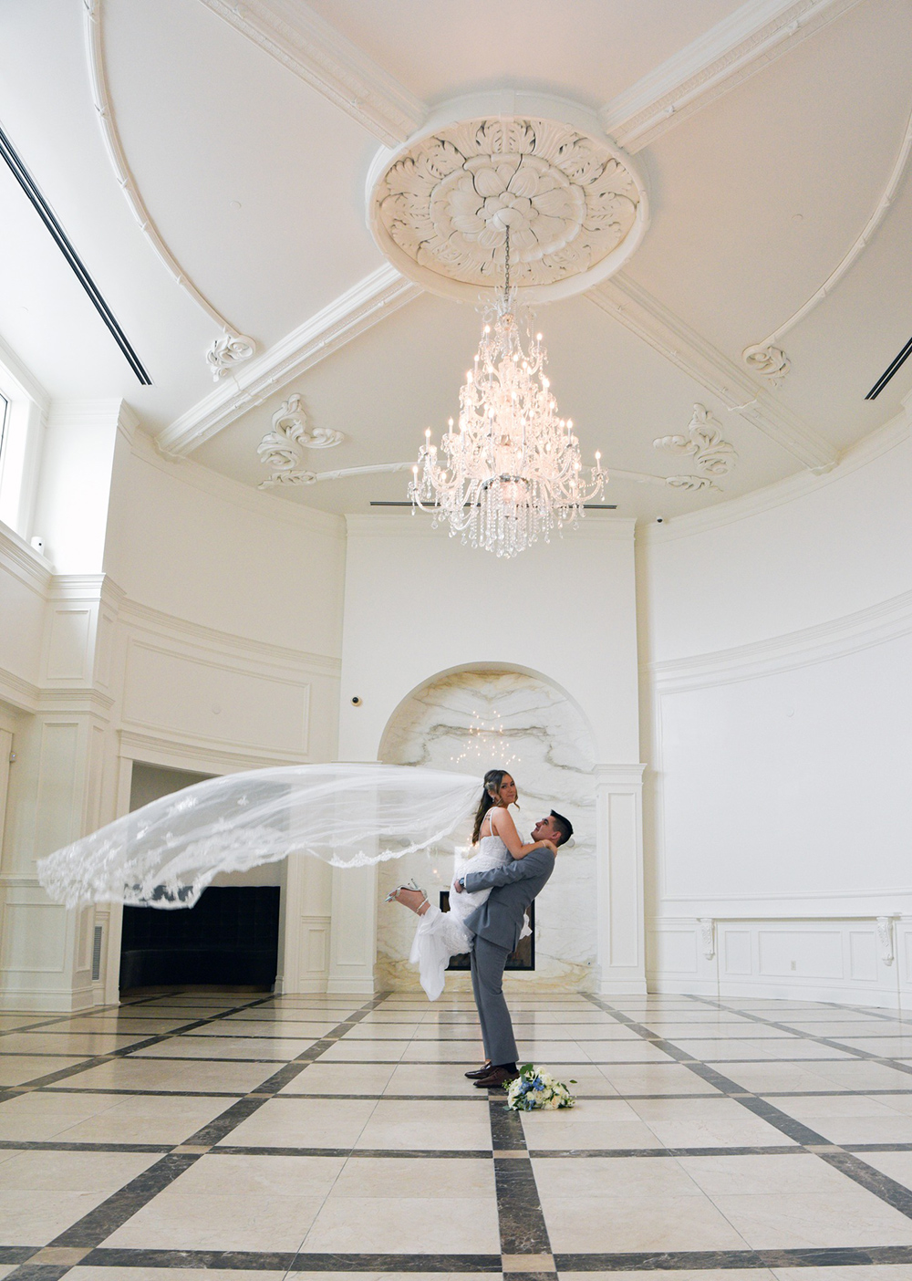 a groom picking up the bride in the atria foyer