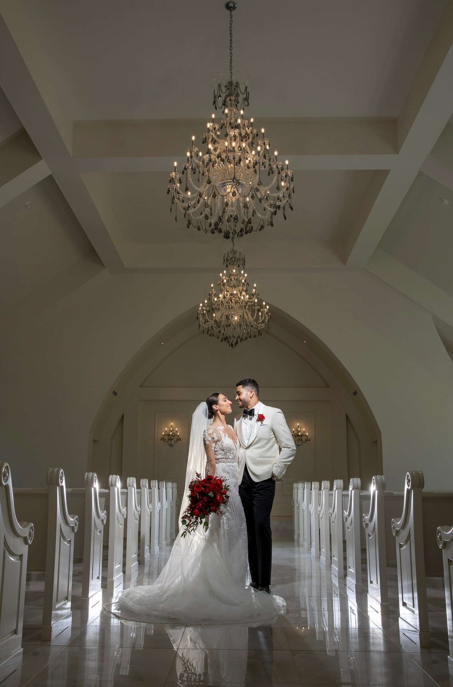 a bride and groom gazing at each other in the aria chapel