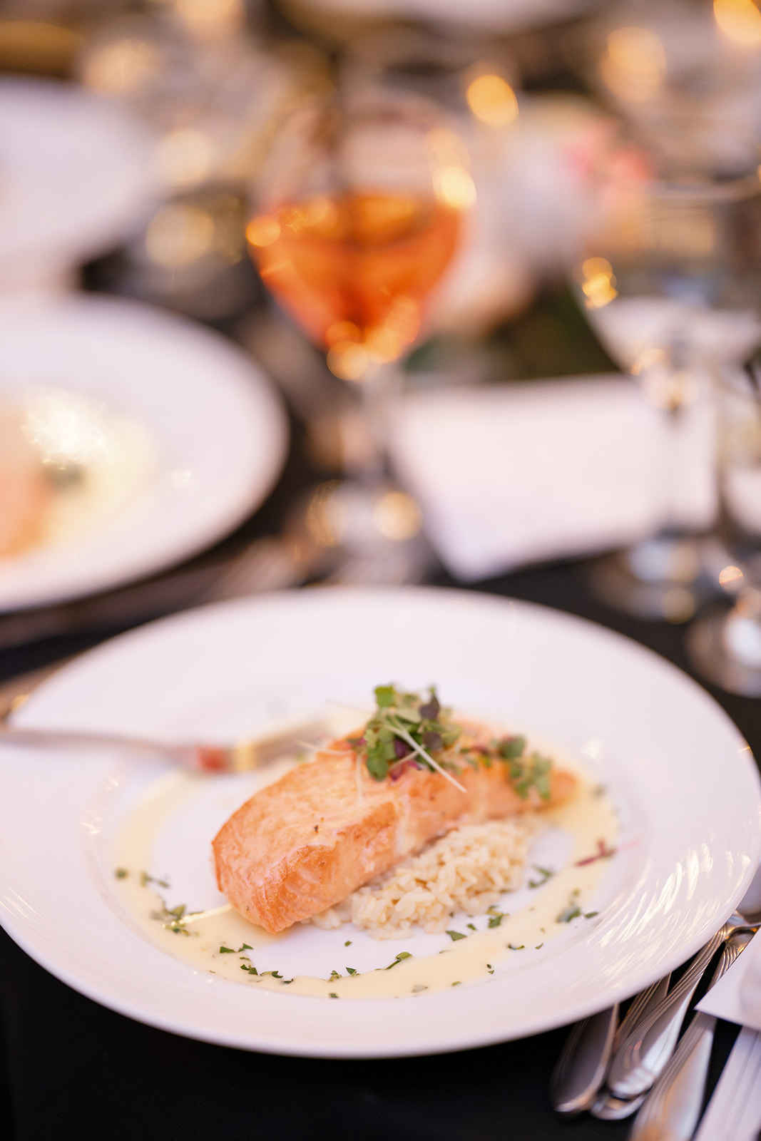 salmon on top of rice topped with herbs