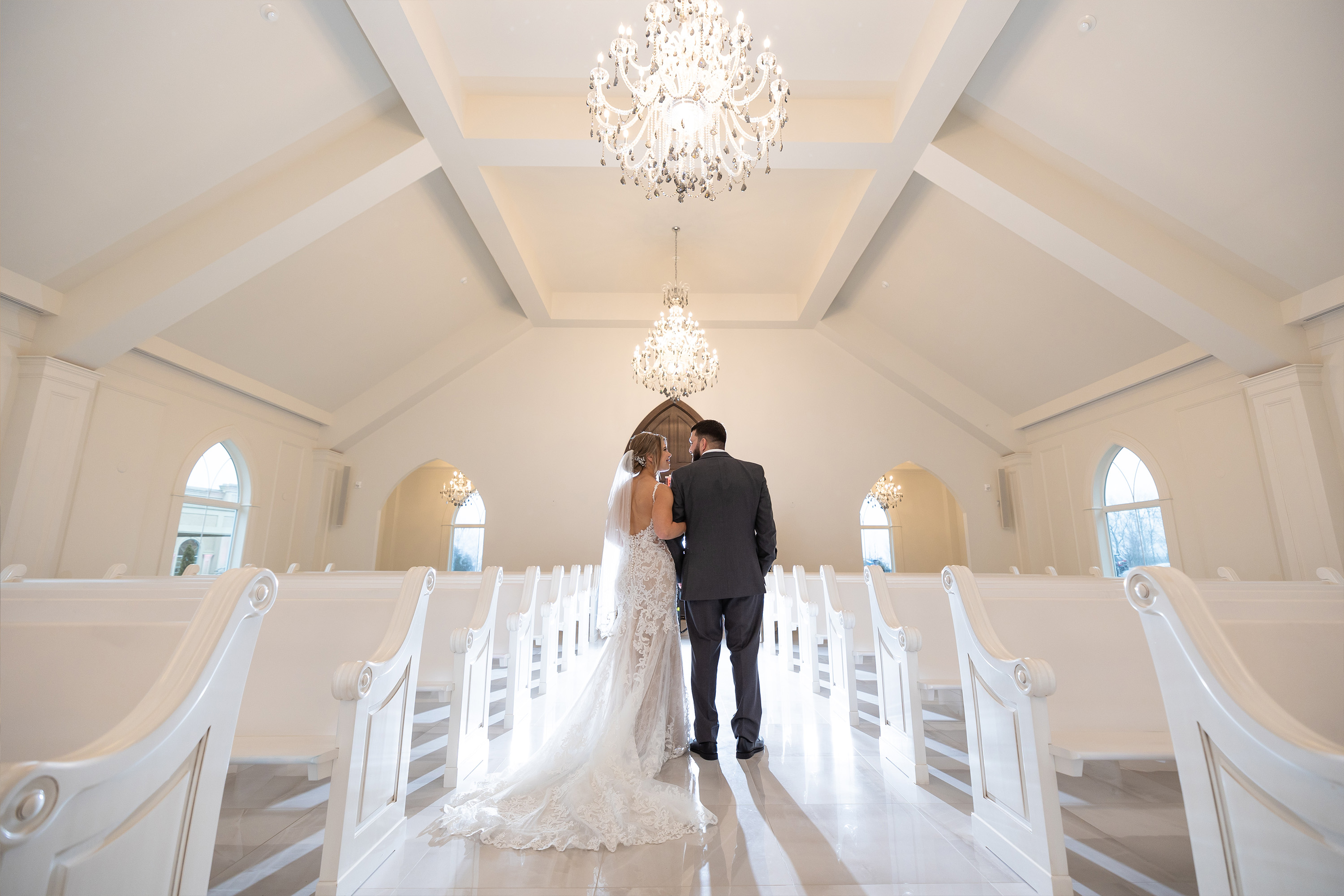 a bride and groom standing inside the aria chapel