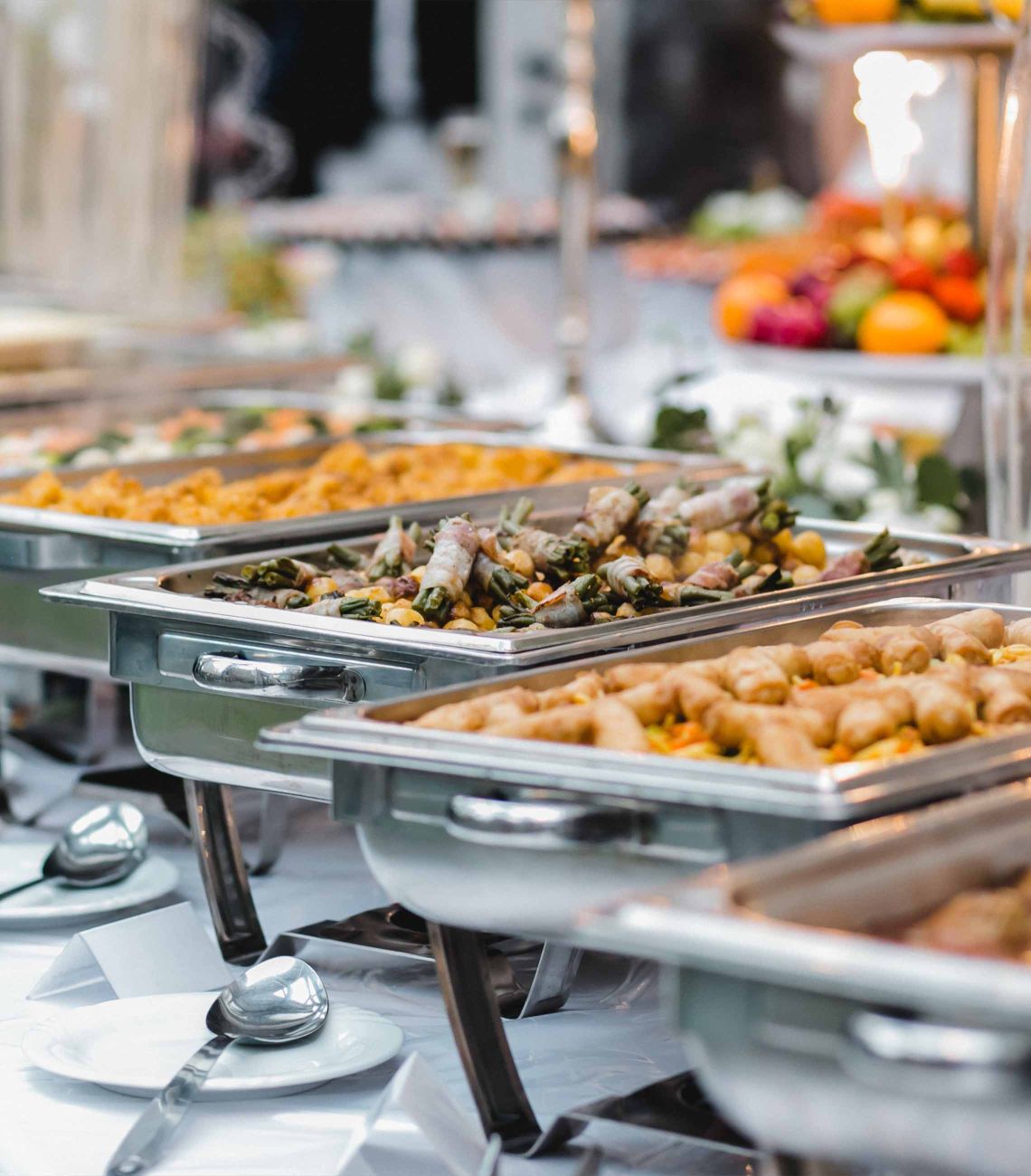 a buffet table of food in chafing dishes